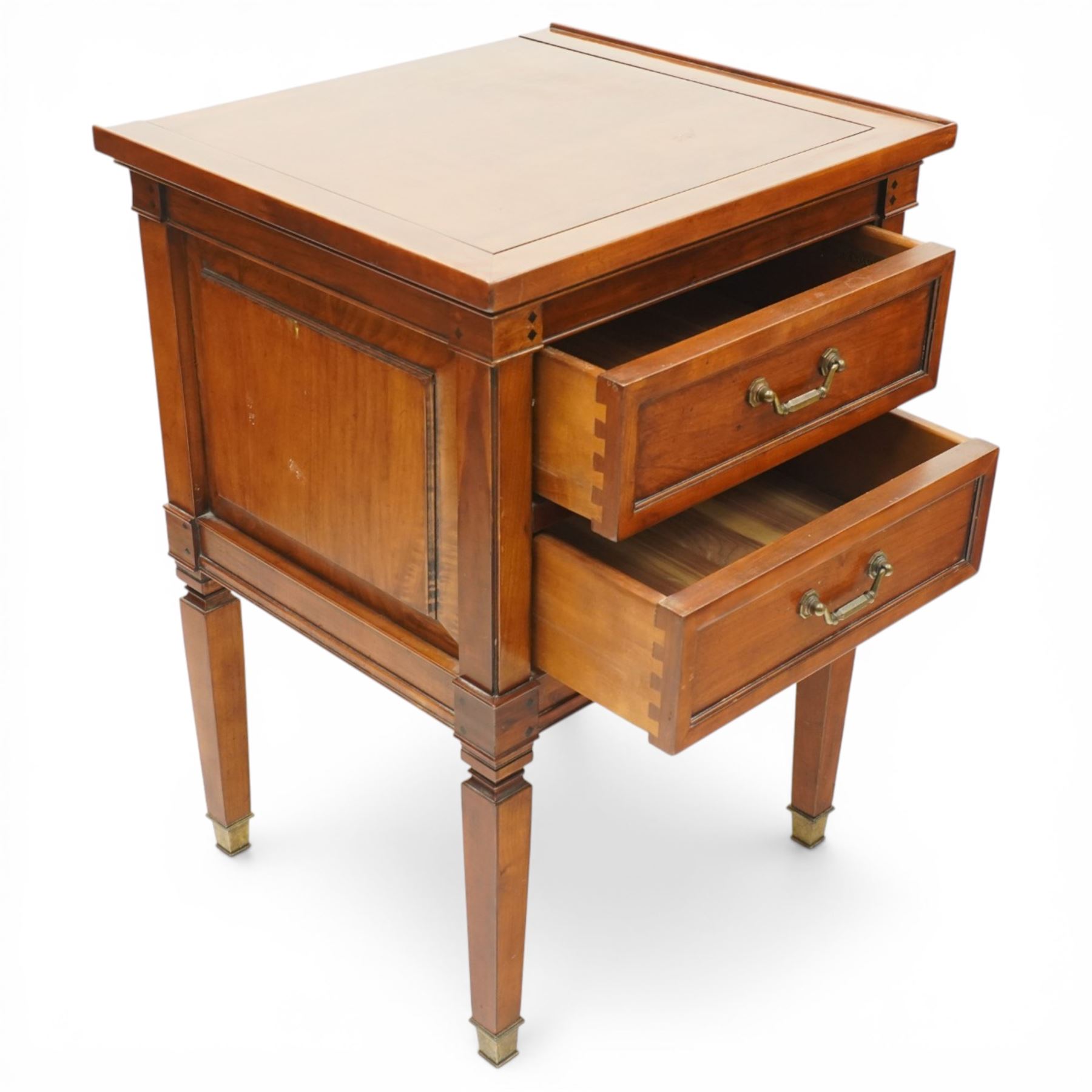Willis & Gambier - pair of 'Directoire' cherry wood bedside tables, rectangular top with cock-beaded edge over two panelled facia drawers, raised on square turned and tapering supports on brass feet