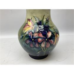 Moorcroft vase of baluster form decorated in the Spring Flowers pattern upon a merging green and blue ground, with impressed and painted marks beneath, H22.5cm