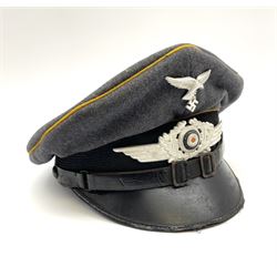 WW2 German Luftwaffe NCO grey cloth peaked cap, orange piping to the crown and bordering the central band, aluminium eagle and cockade insignias, leather strap, interior retains original sweatband inscribed 'Powton', lining has tailor's celluloid diamond marked ' Deutsche-Qualitatsarbeit Christian Haug Berlin No.18 Hochsestr 29 around a CRIHA logo'