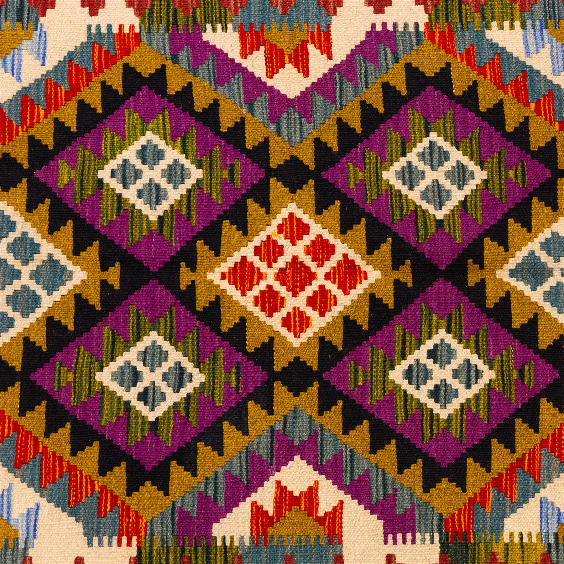 Afghan Maimana flatweave kilim, central field features large bold nested diamond motifs and stylized geometric lozenge patterns on olive purple, blue, and green tone ground, border stripe in teal ground, and fringe