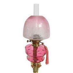 Victorian brass oil lamp, the Corinthian column supporting a cranberry glass burner and opaque etched cranberry glass shade and clear glass chimney, overall H77cm