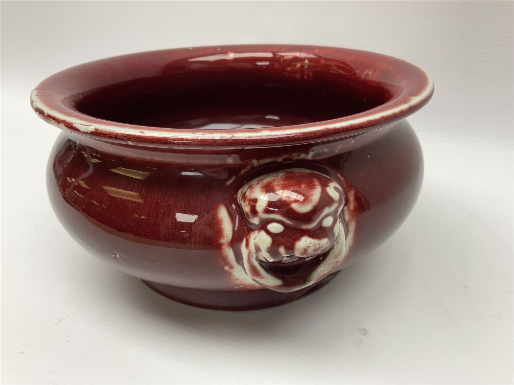 Qing Chinese Sang De Boeuf incense burner, Qing Dynasty, of bombe form with applied lion-mask handles, H11cm