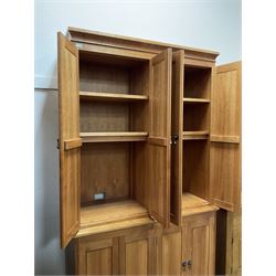 American cherry wood wall unit, top section fitted with two double cupboards enclosing shelves, lower section with four cupboard doors concealing six drawers