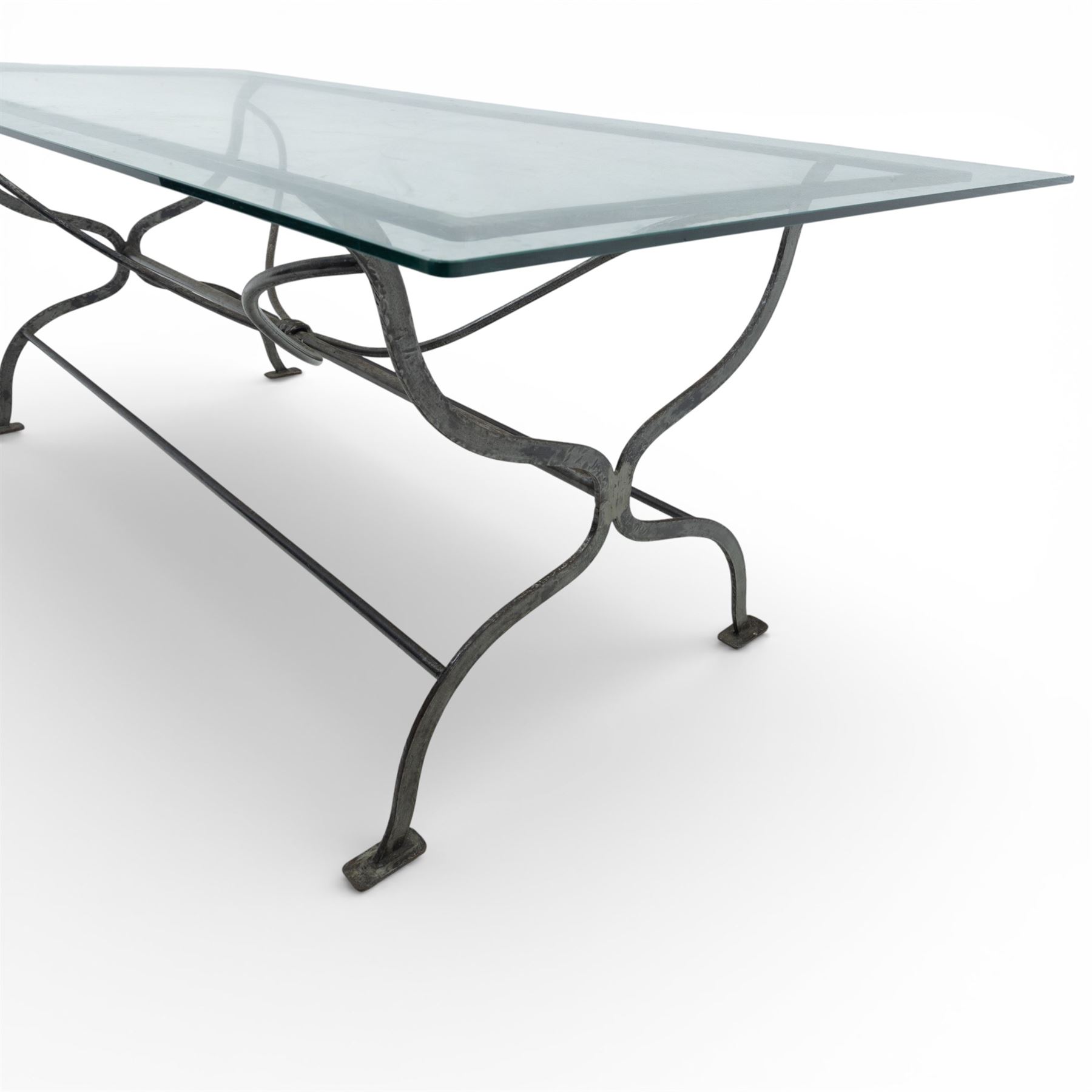 Late 20th century glass dining table, toughened glass top with rounded corners on a wrought metal designed base 