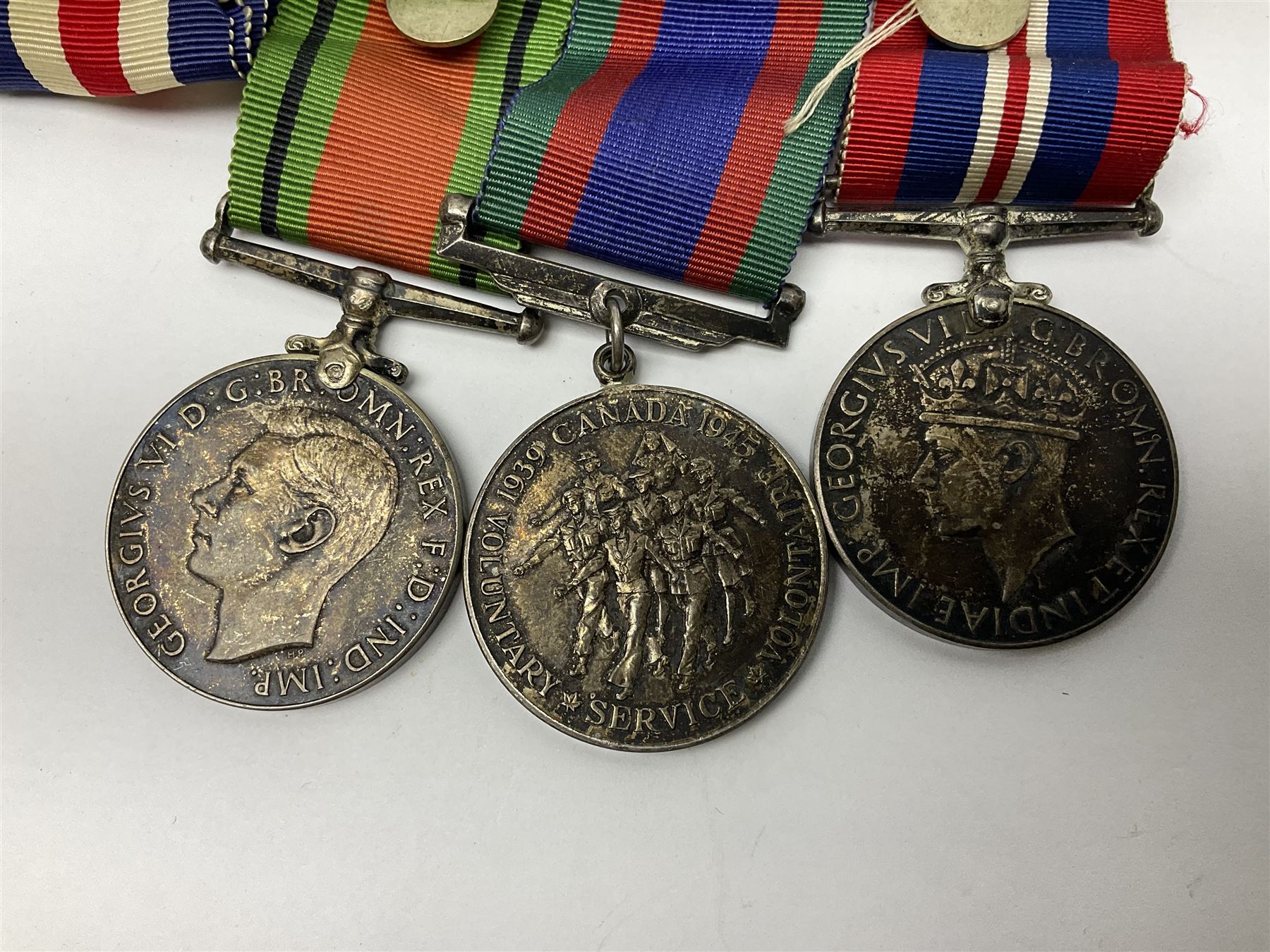 WW2 group of five medals comprising 1939-1945 War Medal, Defence Medal, 1939-1945 Star, France and Germany Star and Canadian Volunteer Service Medal; on wearing bar with ribbons; with a medal box and slip and three photographs