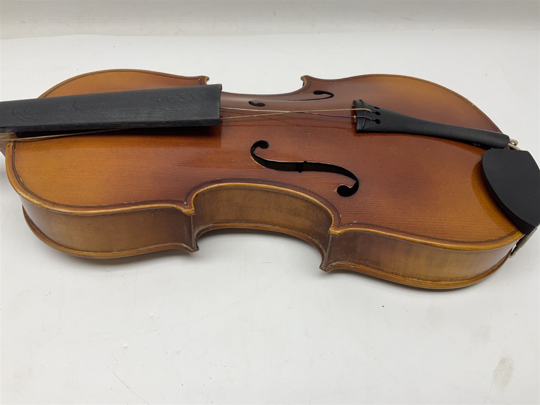 Czechoslovakian violin c1920 with 36cm two-piece maple back and ribs and spruce top, bears label 'Copy of Antonius Stradivarius Made in Czechoslovakia' L59cm; in carrying case; 1950s Czechoslovakian violin; and 195os Czechoslovakian three-quarter size violin; both cased (3)