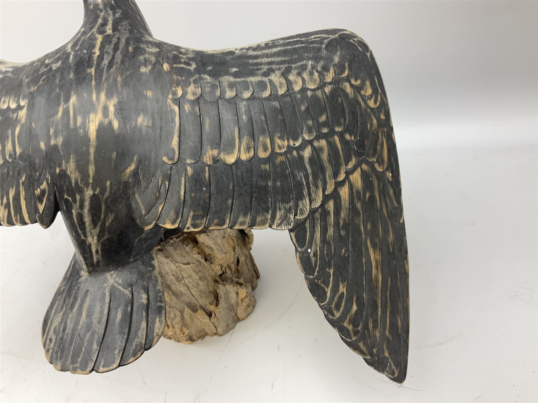 Wooden sculpture of Cormorant aquatic bird on a naturalistic wooden plinth, H46cm