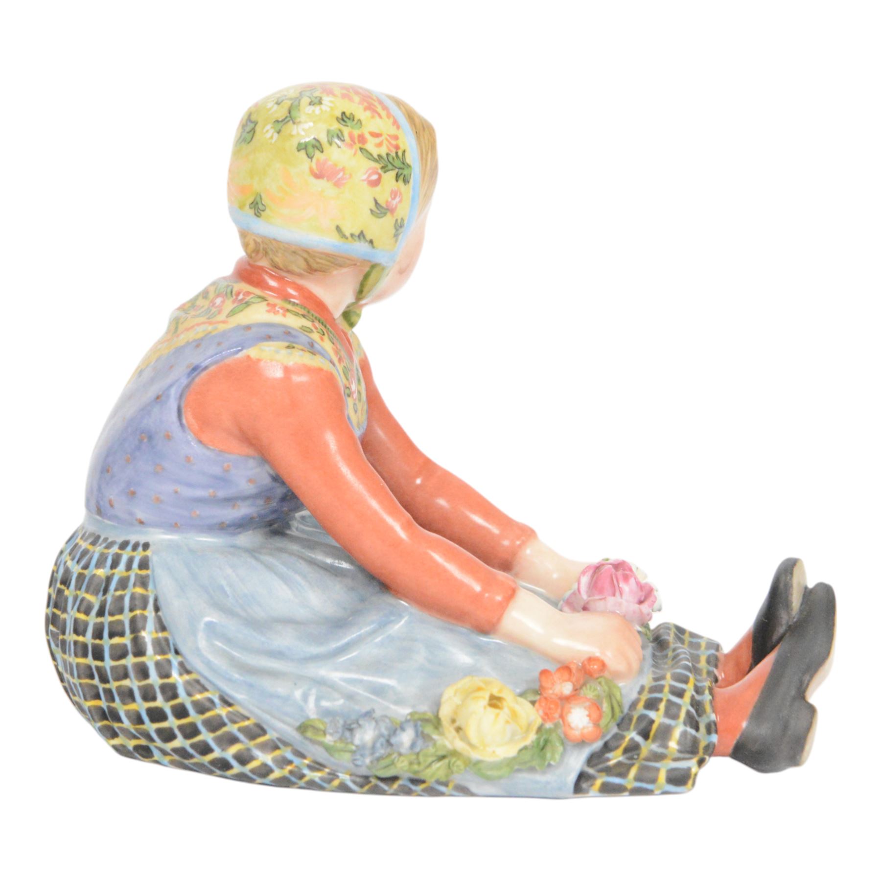 Royal Copenhagen figure, Jutland girl, designed by Carl Martin Hansen, from the Danish National Costumes series, of a girl with a flower garland, marked beneath, H8cm 