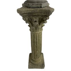 Classical design cast stone female bust depicting Artemis, raised on fluted Corinthian column with acanthus leaf capital, stepped square base, looking right 