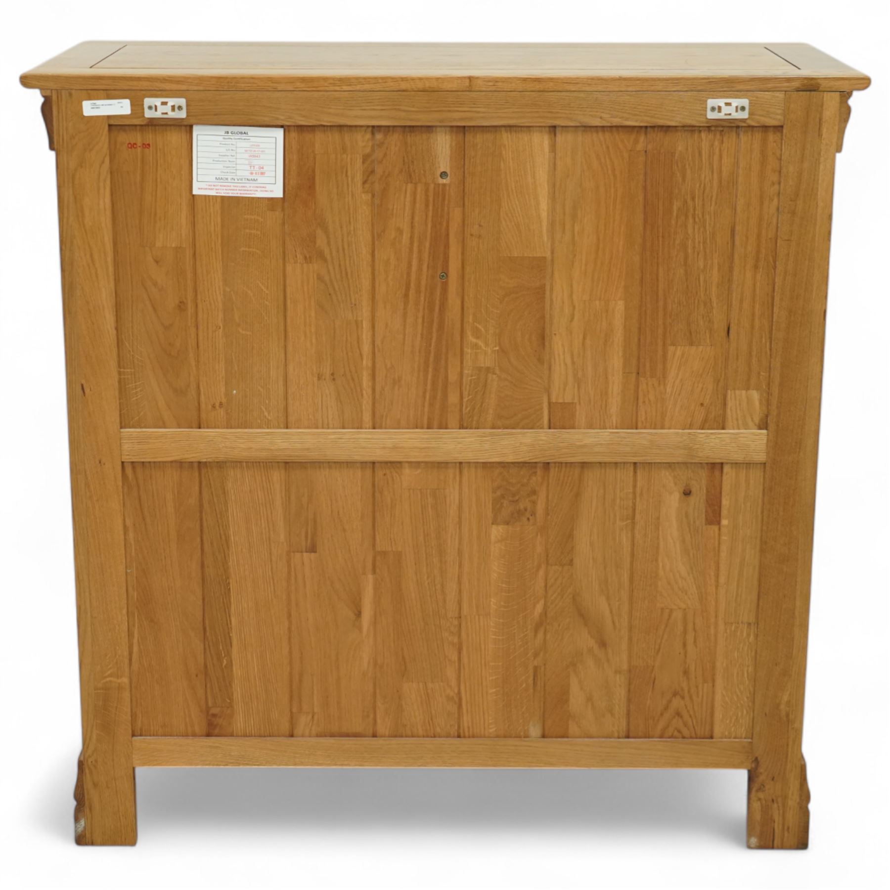 Contemporary solid oak five drawer chest, the rectangular top with inset panels over two short and three full-width drawers, all with brass-effect drop handles, raised on a plinth base