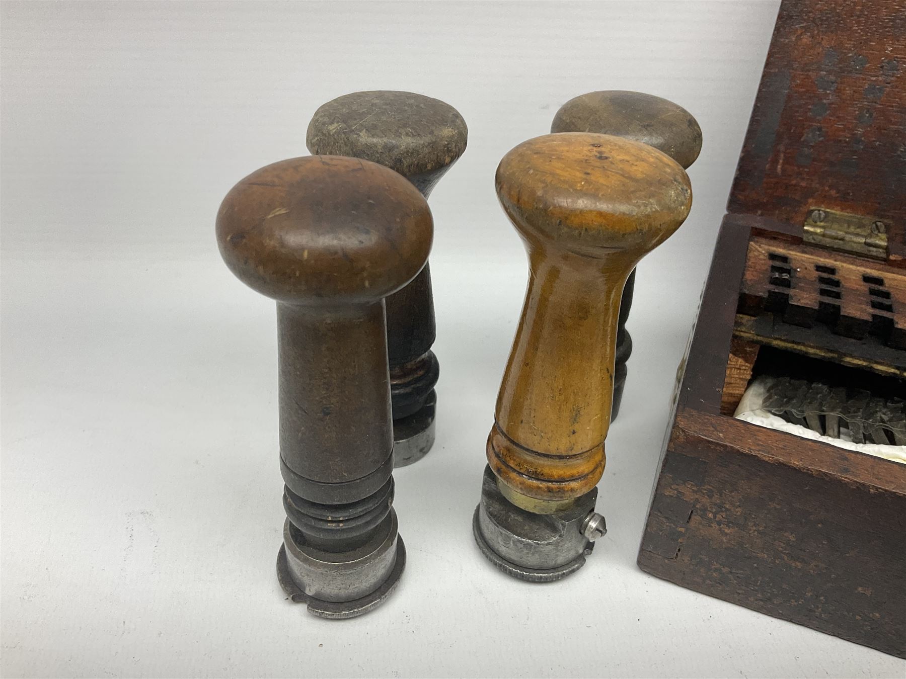 Two Post Office hand stamps 'Heversham Milnthorpe Cumbria' and 'Cimla Neath', together with two hand stamp bodies and various date numbers, housed in a fitted box