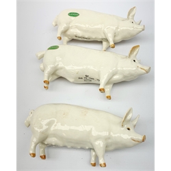 A group of Beswick figures, comprising two Charlie Wall Queen pigs, and a Charlie Wall Boy pig, two donkeys, sheep, and a lamb. 