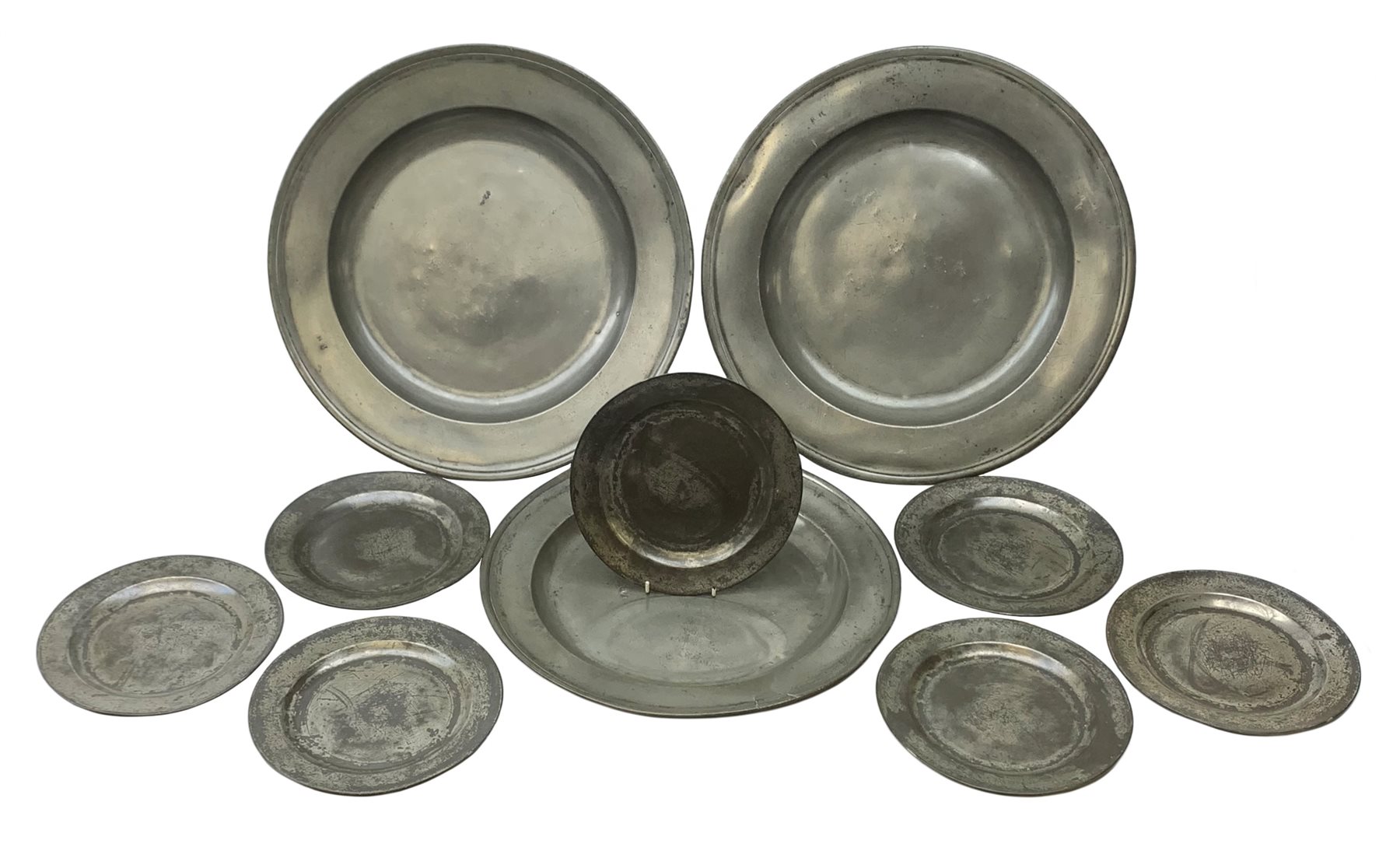 Collection of early 18th century pewter, comprising three large chargers, and seven plates, with various marks and touch marks verso, including the Crowned Rose and shield pseudo 'hallmarks', chargers D46cm and D42cm, plates D23cm.