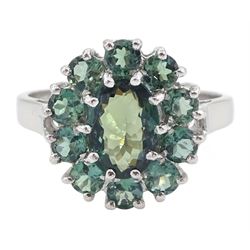 18ct white gold green sapphire cluster ring, oval cut sapphire of approx 1.40 carat, surro...