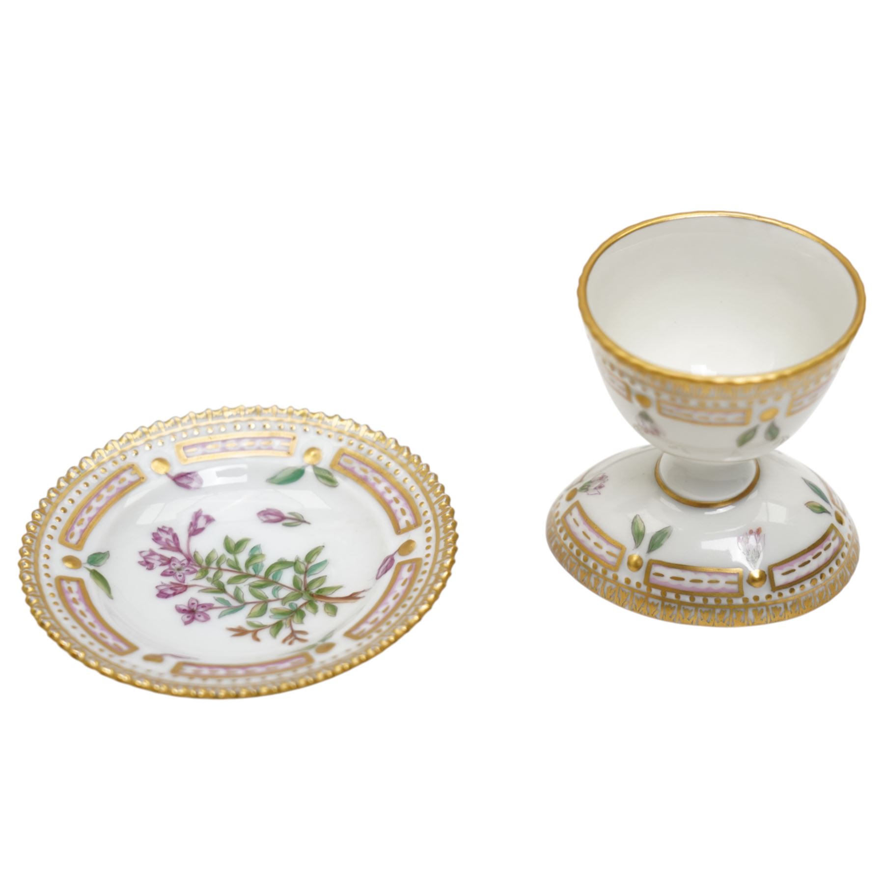 Royal Copenhagen Flora Danica wares, comprising covered mustard pot with naturalistically modelled vine handles and decorated with Cushion Pink (Cucubalius Acaulis) H8cm, milk jug decorated with Maiden Pink (Dianthus Deltoides) H7cm, covered dish decorated with Dwarf Milkwort (Polygala Amarum) W8cm, oval salt cellar decorated with Alpine Squill (Scilla Bifolia) W11cm, egg cup, pin dish and cased hand mirror, various Latin specimen inscriptions to base, all with printed and painted marks beneath (7)