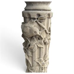 Weathered cast stone birdbath, the kylix shaped bowl with fluted body, raised on a fruiting foliate vine decorated fluted pedestal with upper knop and bird and fieldmouse motifs, shaped square base with scroll feet