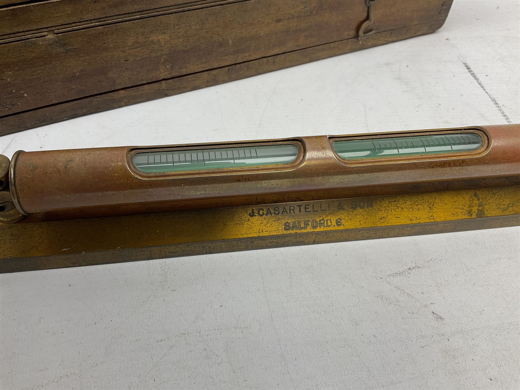 Engineers heavy brass spirit level by J Casartelli & Son, Salford,in original wooden case, box L45cms