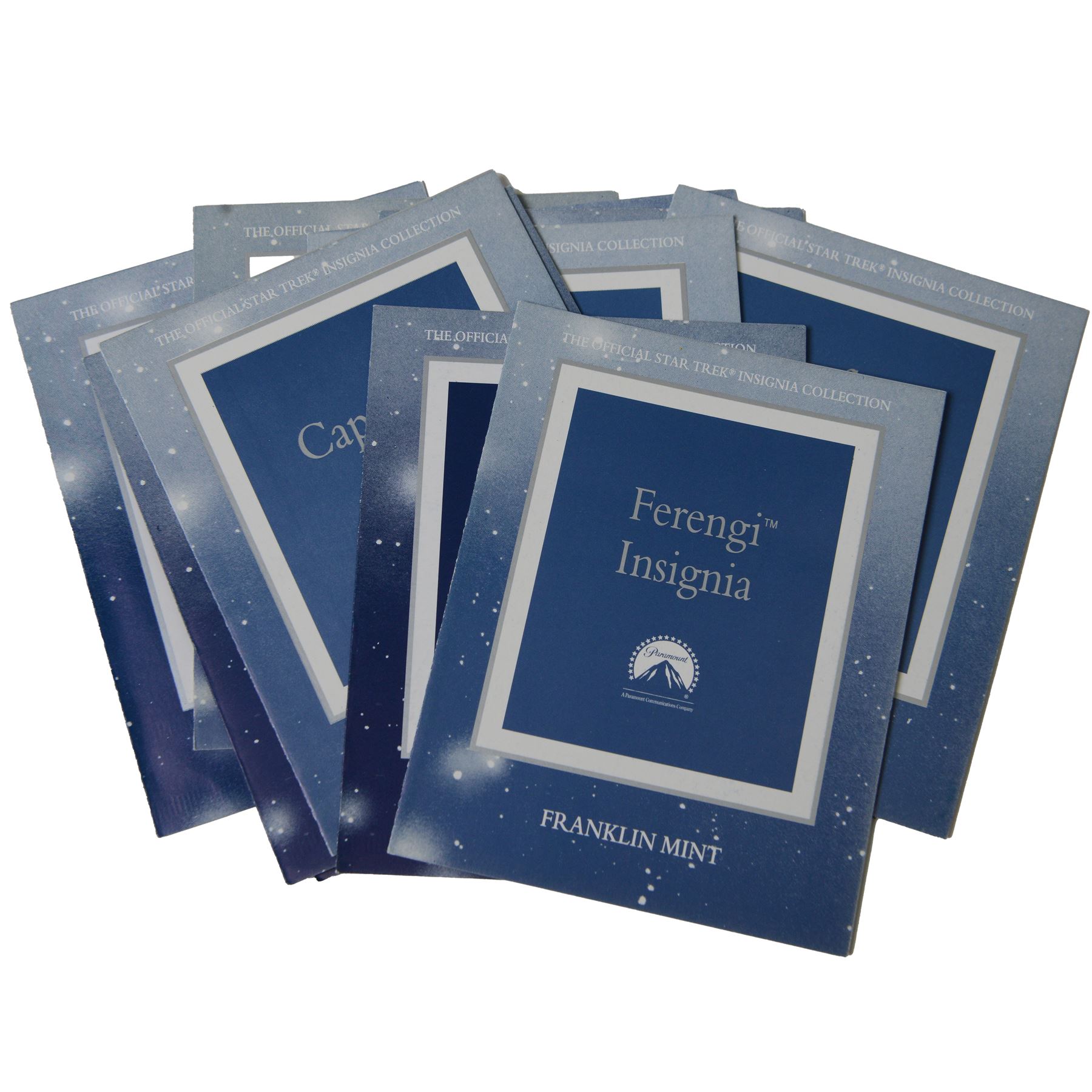 Franklin Mint The Official Star Trek Insignia Collection, set of twelve sterling silver insignia with gold plated decoration, all stamped 925 sterling with certificates of authenticity, contained within a wooden glazed display case, case H56cm