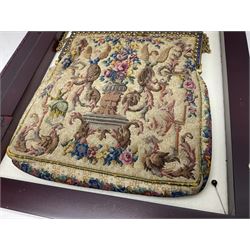 Continental petit point evening bag, with enamel and pearl details, in wooden display frame, together with a snake skin handbag and three other vintage bags
