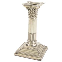 Pair of early 20th century silver Corinthian column candlesticks, upon square stepped filled bases, hallmarked Walter Latham & Son, Sheffield 1913, H16cm