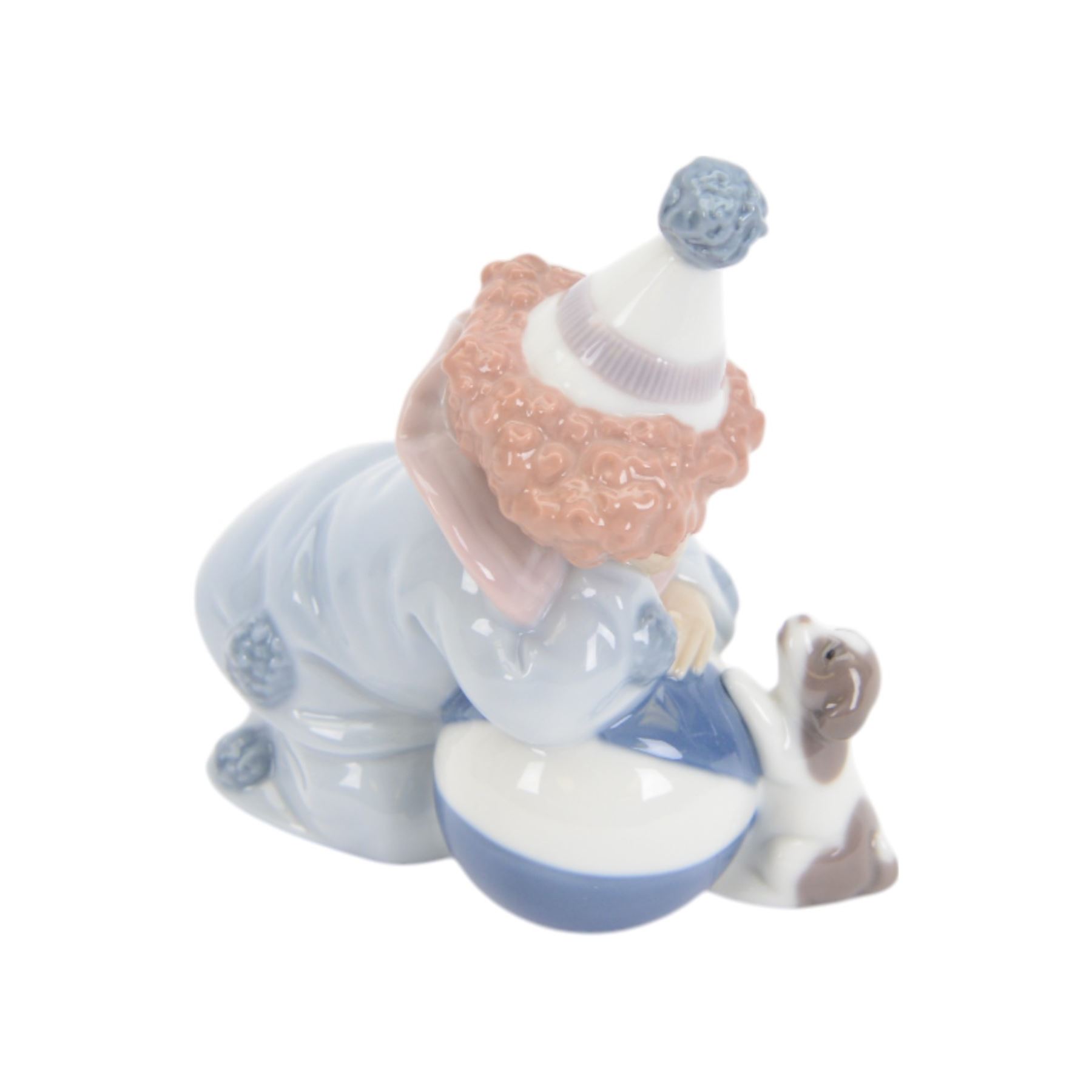Four Lladro clown figures, comprising Having a Ball 5813, Little Clown 5811, Clown with Puppy 5278 and Pierrot with Concertina 5279