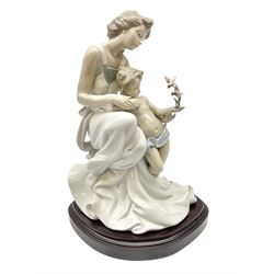 Lladro figure, Where Love Begins, modelled as a mother of child feeding birds, on a mahogany base, limited edition 3413/4000, with original box, no 7649, year issued 1995, year retired 1996, H36cm 