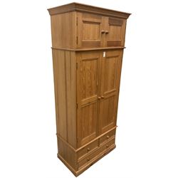Solid pine double wardrobe, fitted with top box, enclosed by panelled doors, two short and one long drawer, on plinth base 