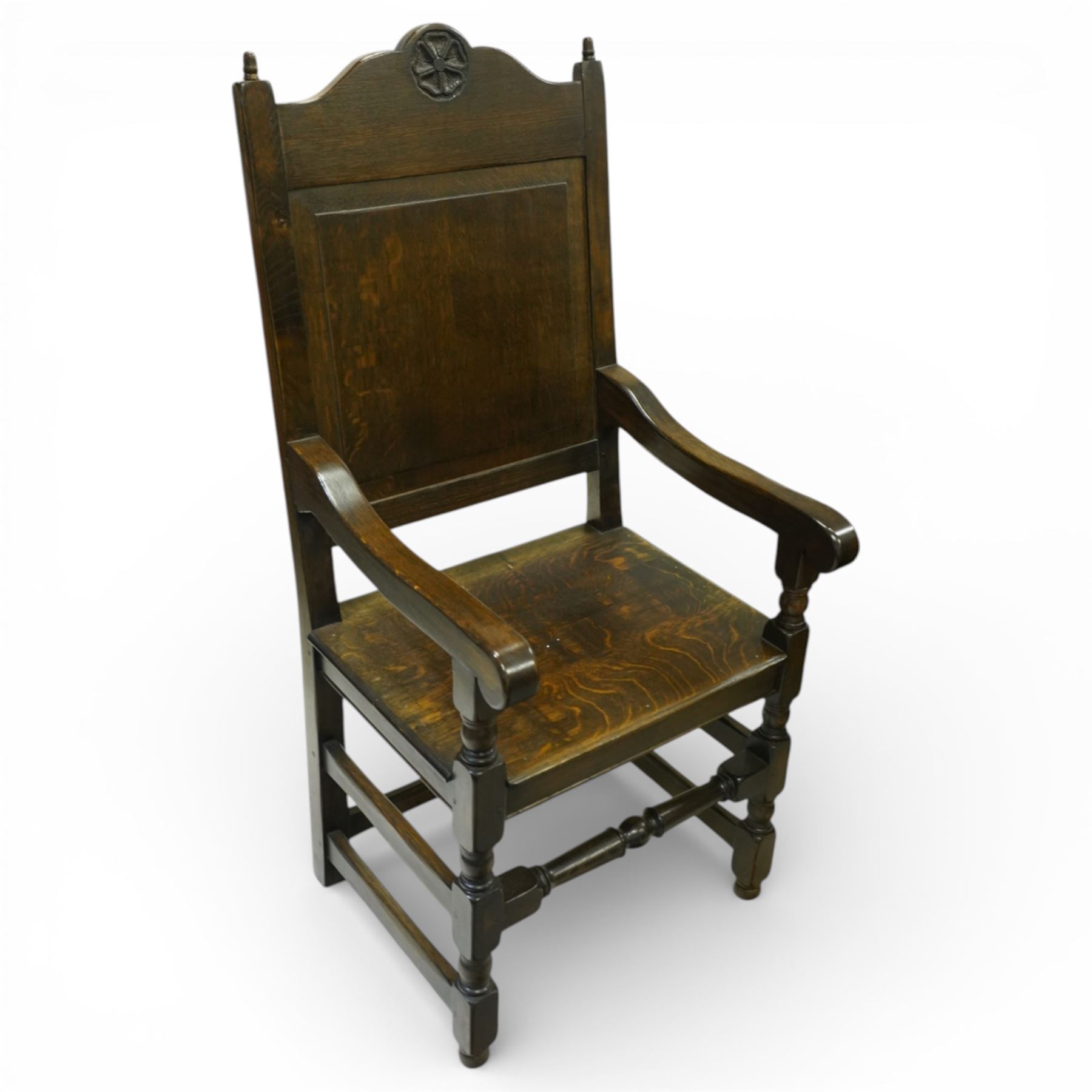 20th century oak refectory style dining table and eight chairs (6 + 2), rectangular top on two large carved baluster pedestal supports with leaf decoration, on splayed trestle bases joined by a stretcher, with eight matching oak dining chairs, each with Yorkshire rose carved cresting rail, panel back and solid seat, raised on turned supports united by stretchers