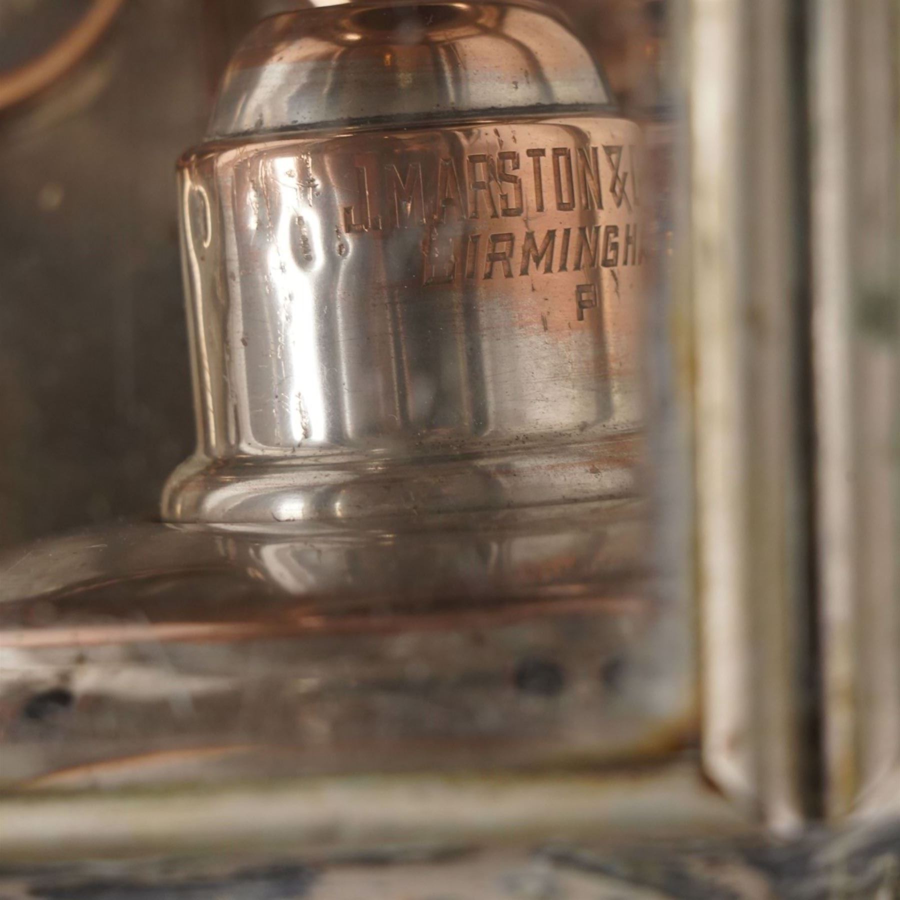 J Marston & Co. Ltd. (Birmingham) - pair of Victorian copper glazed and white metal carriage lamps with toleware outer-body, hexagonal body with faceted bevelled glass and reflective panels one inset with circular red reverse light, surmounted by a turned copper finial over a pagoda form chimney, raised on turned copper spoke, maker engraved to candle mount