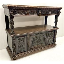 Victorian carved oak buffet sideboard, rectangular moulded top over a leaf and egg and dart cornice, two drawers with scroll acanthus leaf and mask carved fronts, two figures carved supports, one depicting a piper and one a flute player, the lower section with central panelled door with relief carved tavern scene flanked by two further carved panels