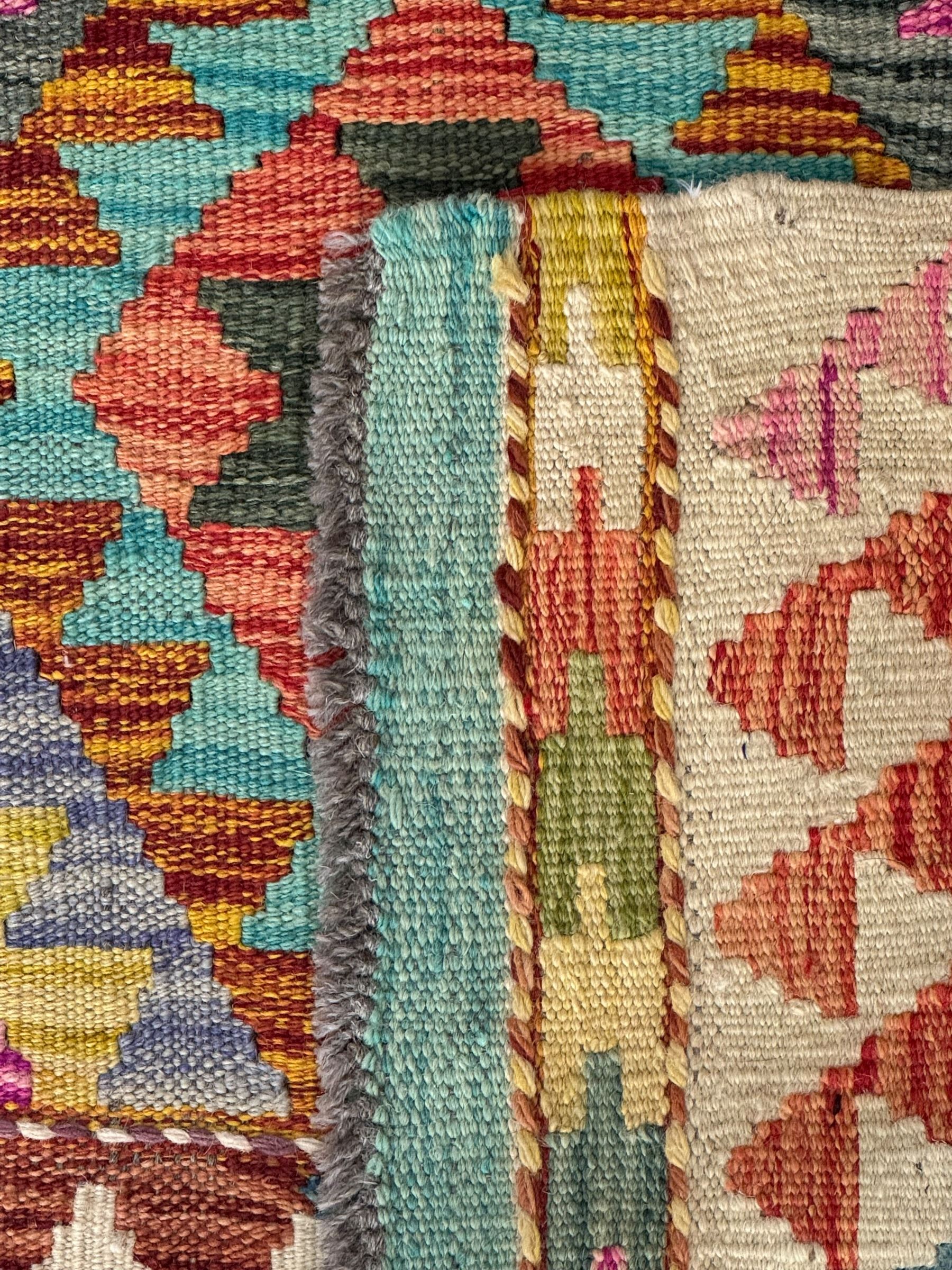 Tibetan-design handwoven rug, deep red field with three central medallions in yellow and blue, traditional yellow key border, white fringes on both ends