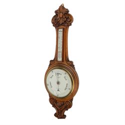 1920s aneroid barometer in a carved oak case.