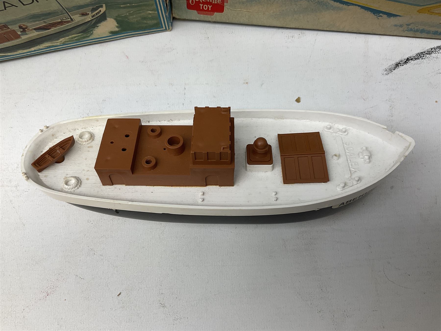 Five model boats - Sutcliffe clockwork Tiger Speedboat; boxed; Motor Sailor battery operated yacht; boxed; Waterline battery operated police launch; boxed; and Tri-ang Scalex 'Aberdeen' North Sea Drifter; boxed, with another similar unboxed (5)