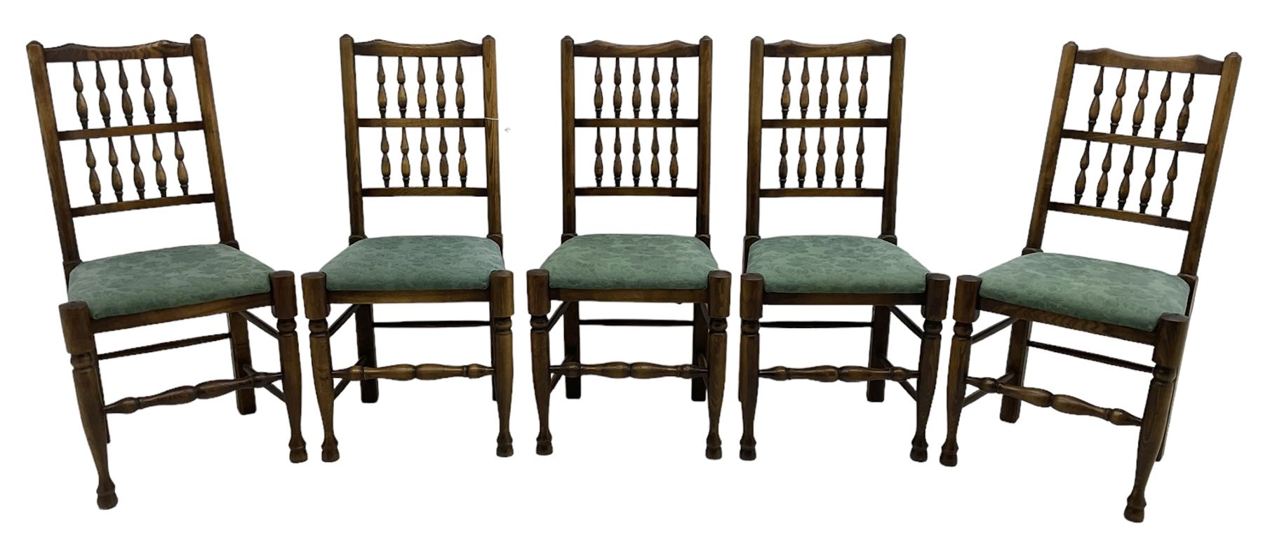 Set of five Lancashire design elm spindle back chairs, shaped cresting rail over two rows of five spindles, upholstered drop-on seats, on turned front supports united by turned stretchers  