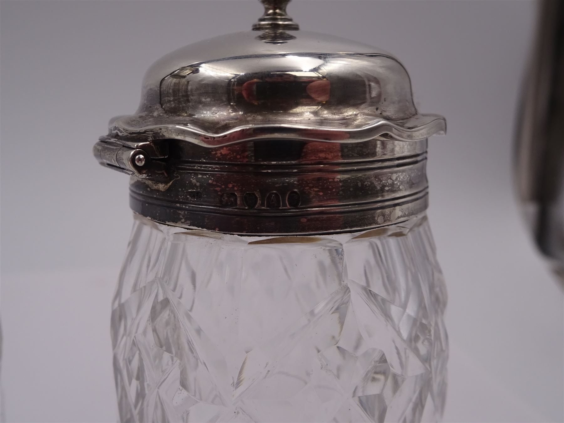 Late 18th century silver cruet stand, of oval form, with pierced sides upon four bun feet, hallmarked to handle Hester Bateman, all other hallmarks indistinct, together with five matched silver mounted cut glass cruet bottles, including some later Victorian examples, hallmarks predominantly indistinct, stand H20cm