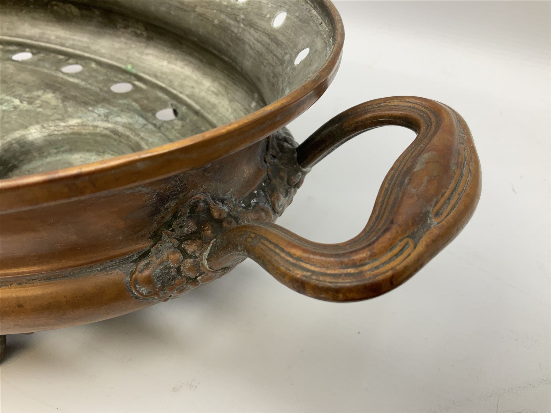 Agricultural copper corn funnel, H32.5cm, another similar copper funnel and copper warming platter of oval form, with twin handles on four supports, with removeable warming plate, L49cm