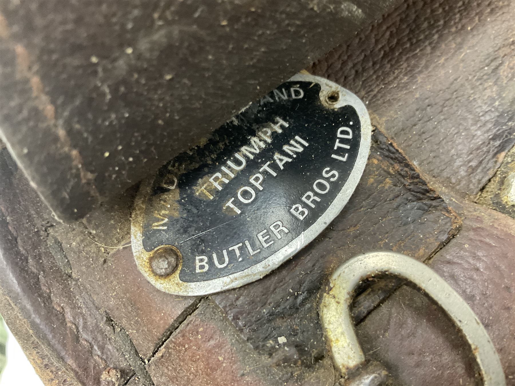 Collection of nine saddles, mainly havana leather to include a racing saddle and a Goodwin saddle, some with stirrups and leathers 