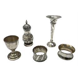 Collection of silver, to include mid 20th century napkin ring, Victorian shaker ornately decorated, hallmarked Chester 1895, trumpet vase with filled base, egg cup and another napkin ring, all stamped with hallmarks, Total weight - 141g, without vase 113g