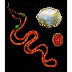  19th/early 20th century brooch depicting a Lake District scene on ivory, coral and green bead necklace and a carved wax gilt brooch  