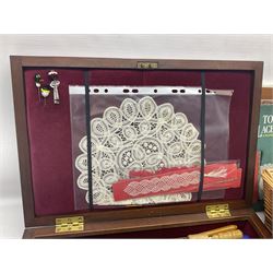 Collection of lace making wooden bobbins, together with lace making books and a handmade storage box