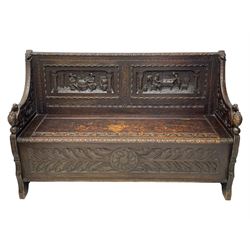 19th century carved oak box-seat hall bench, foliage carved upper rail over two panels carved with Flemish design tavern scenes, shaped down-swept arms carved with scrolling foliage and winged bird mask terminals, hinged seat carved with further scrolls and leaf lunettes, the front panel carved with elongated leaves and central flower head