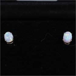 Pair of 9ct gold oval opal stud earrings, boxed