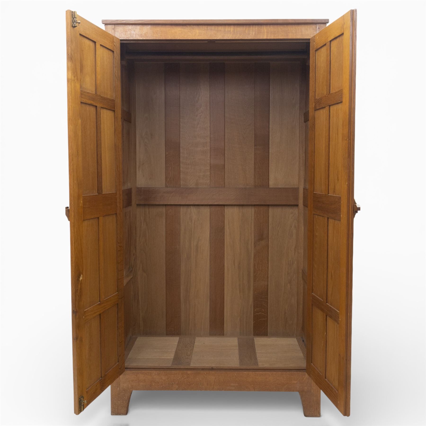 Acornman - oak adzed panelled double wardrobe, with wrought iron hinges and carved oak latch revealing a single clothes rail, with signature carved acorn to top right, by the workshop of Alan Grainger, Brandsby