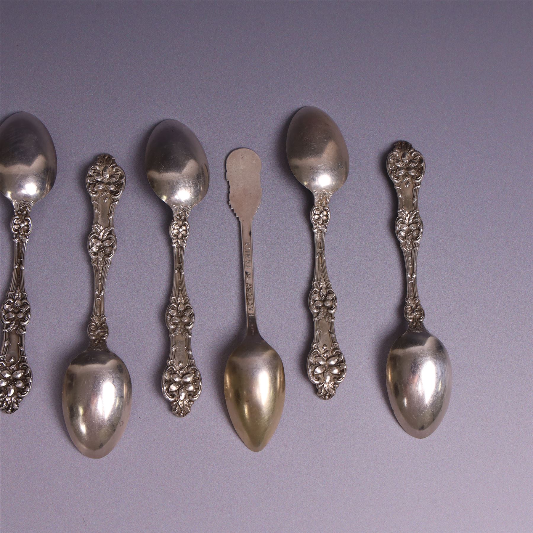 American silver tea and coffee spoons, comprising set of six coffee spoons with embossed lily decoration, set of six teaspoons with embossed rose decoration, both with engraved initials and a pair of Larkin coffee spoons, all stamped Sterling