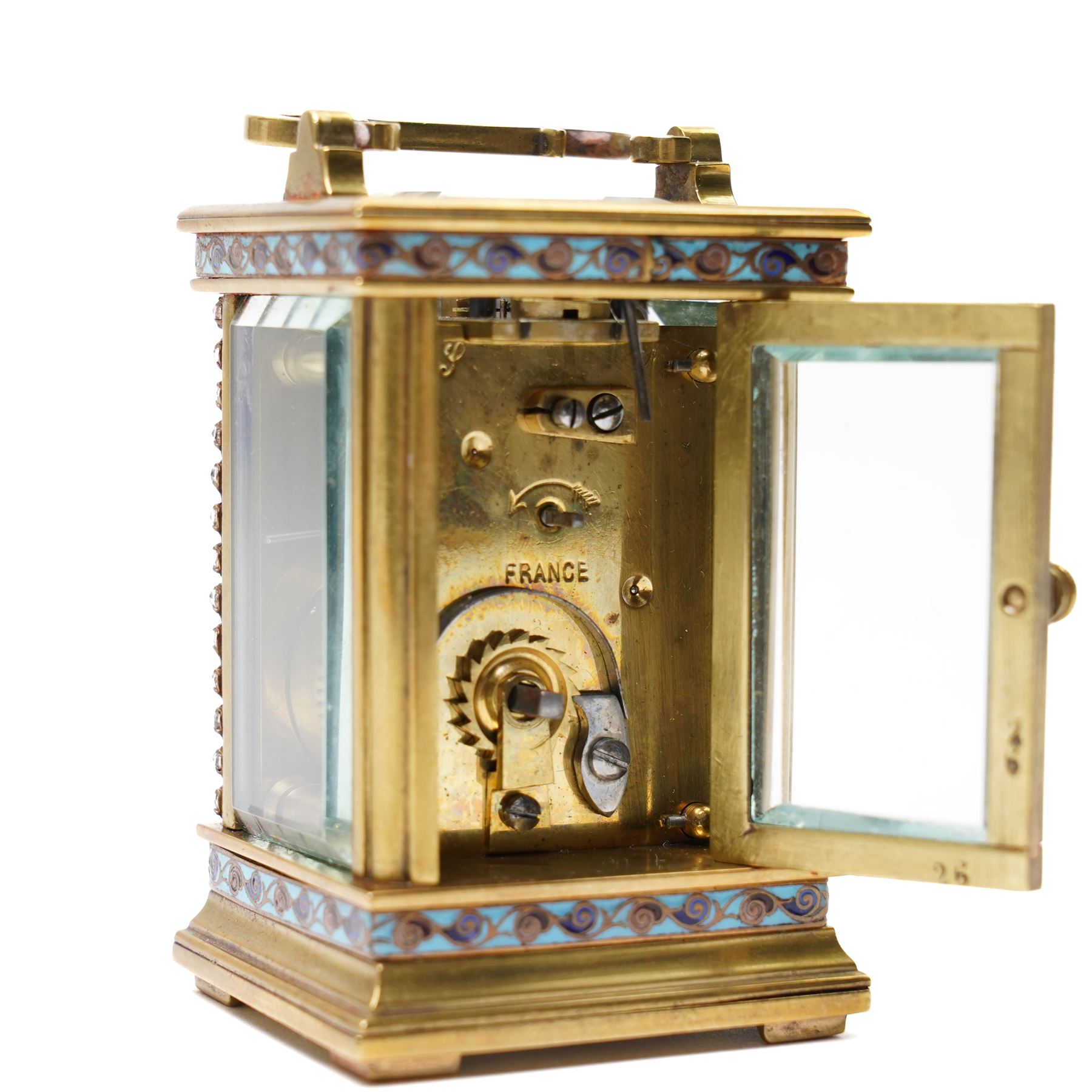 French- Edwardian miniature brass 8-day timepiece carriage clock with cloisonné panels to both base and cornice and paste gems to the front columns, decorative porcelain dial with a floral swag, blue Arabic numerals, minute track and pieced steel hands, square viewing glass to the top with a silvered lever escapement, with original leather bound traveling case.