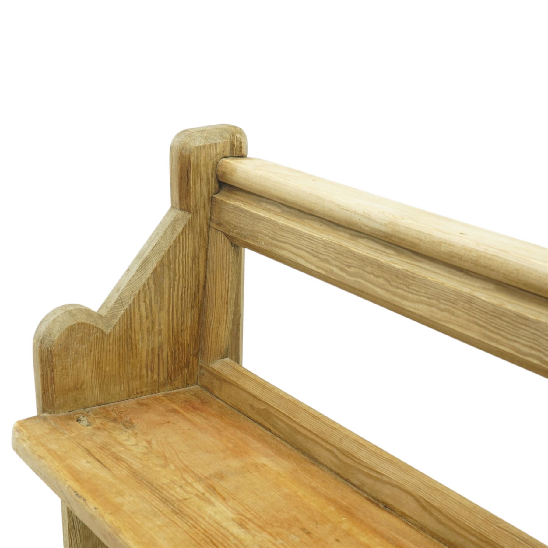 19th century pine pew of small proportions, open rectangular back with panelled frame, rounded top rail and plank seat, shaped slab ends with chamfered detail
