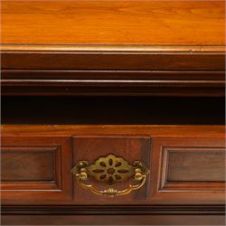 Late Victorian mahogany mirrored back sideboard, the mirror back with three bevelled mirror plates above a single shelf, rectangular moulded top over two frieze drawers with brass handles, above a twin panelled cupboard, carved recessed panels decorated with flowers and foliage, fluted uprights, raised on turned feet