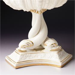 19th century Royal Worcester comport, painted with gilt on a cream ground, the stem formed as three entwined dolphins raising the shell shaped bowl, faint mark to base, H19.5cm