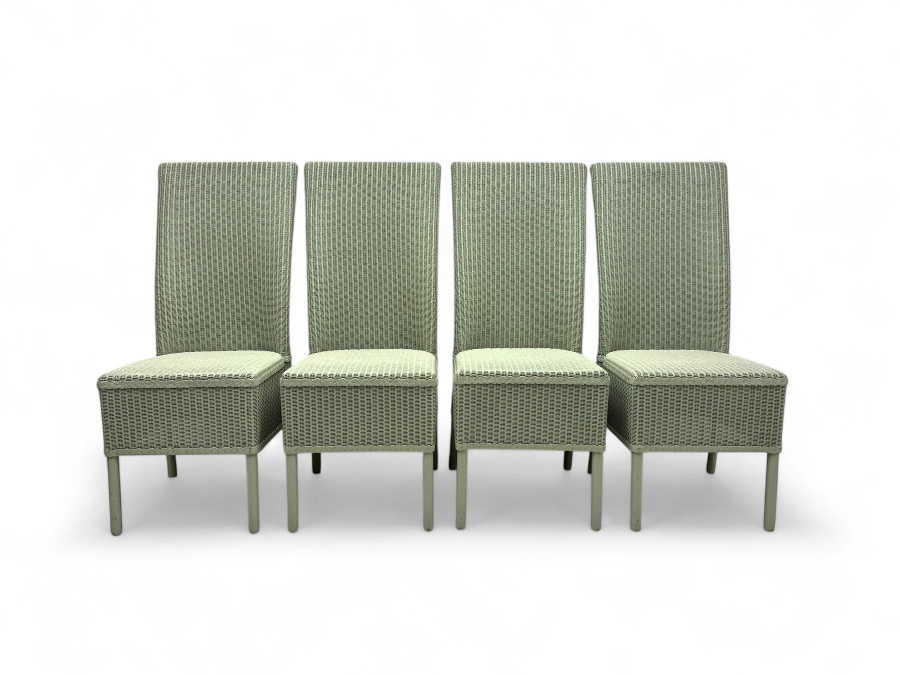 Set of four Lloyd Loom dining chairs, each with woven high back and seat in sage green finish, raised on matching painted tubular supports