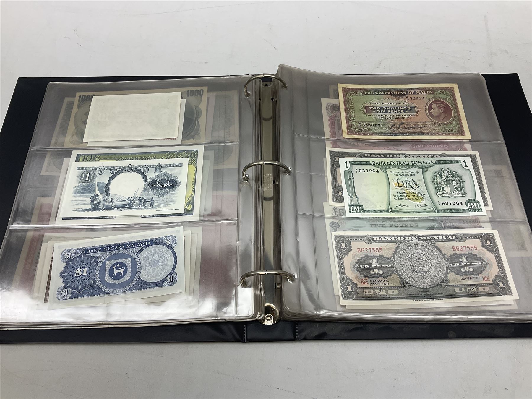 World banknotes, including Queen Elizabeth II The States of Jersey one pound 'DB202703', five pounds 'BB527762' and ten pounds 'AB651481', reserve bank of New Zealand two dollars '1L3 741894', King George V Straits Settlements one dollar 1st January 1935 'F/83 28924', various Bank of England notes etc, housed in two ring binder albums